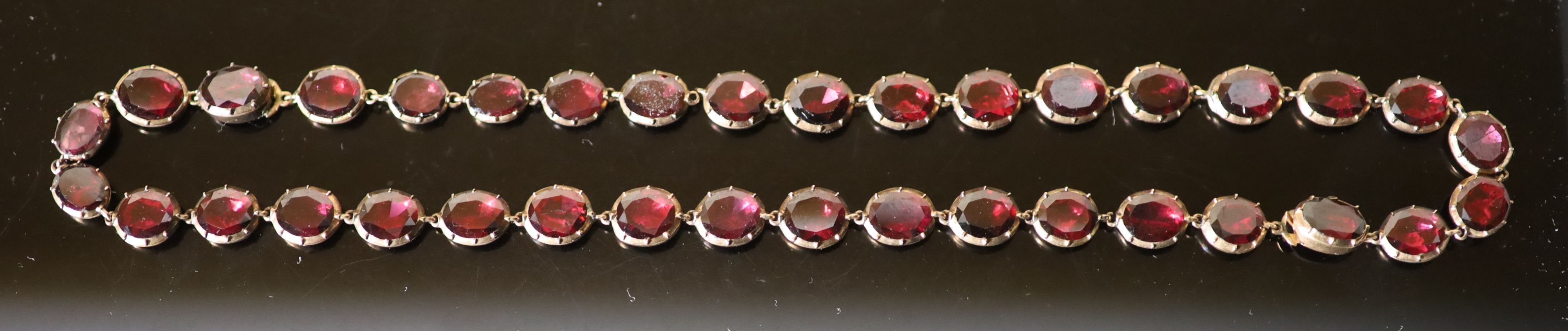 An early 19th century gold and garnet set necklace,
